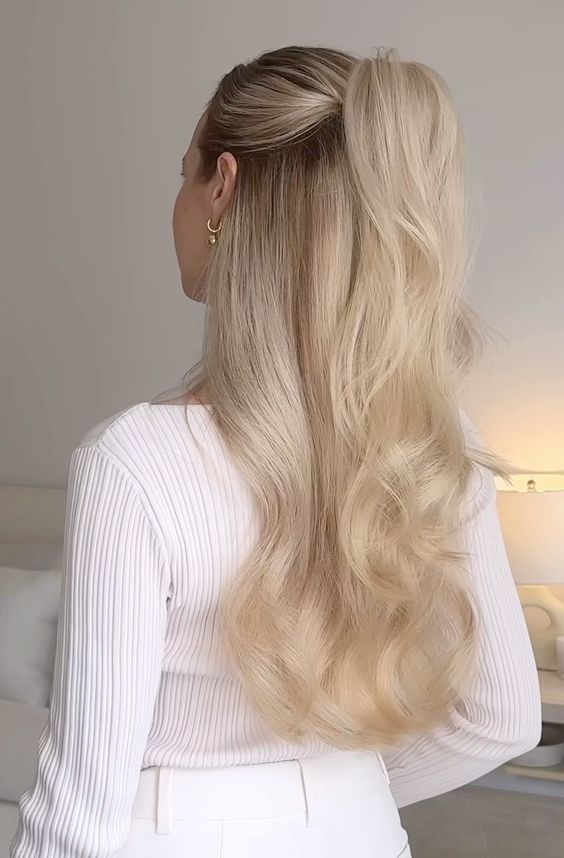 Half up, half down hairstyle featuring a woman in a white top.
