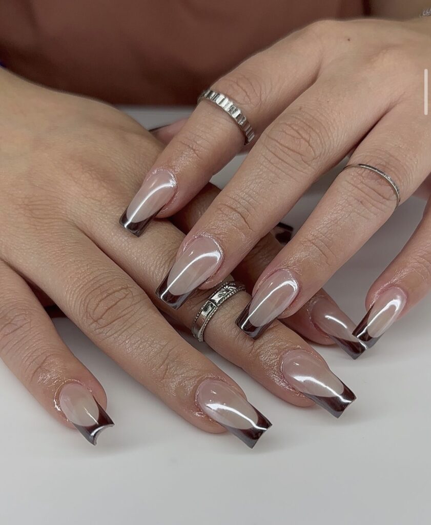 Neutral base nails with subtle brown tips.