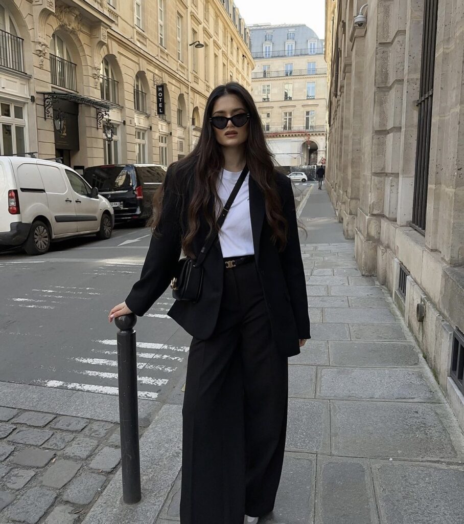 Sleek black trousers, with a black blazer and a classic white t-shirt.