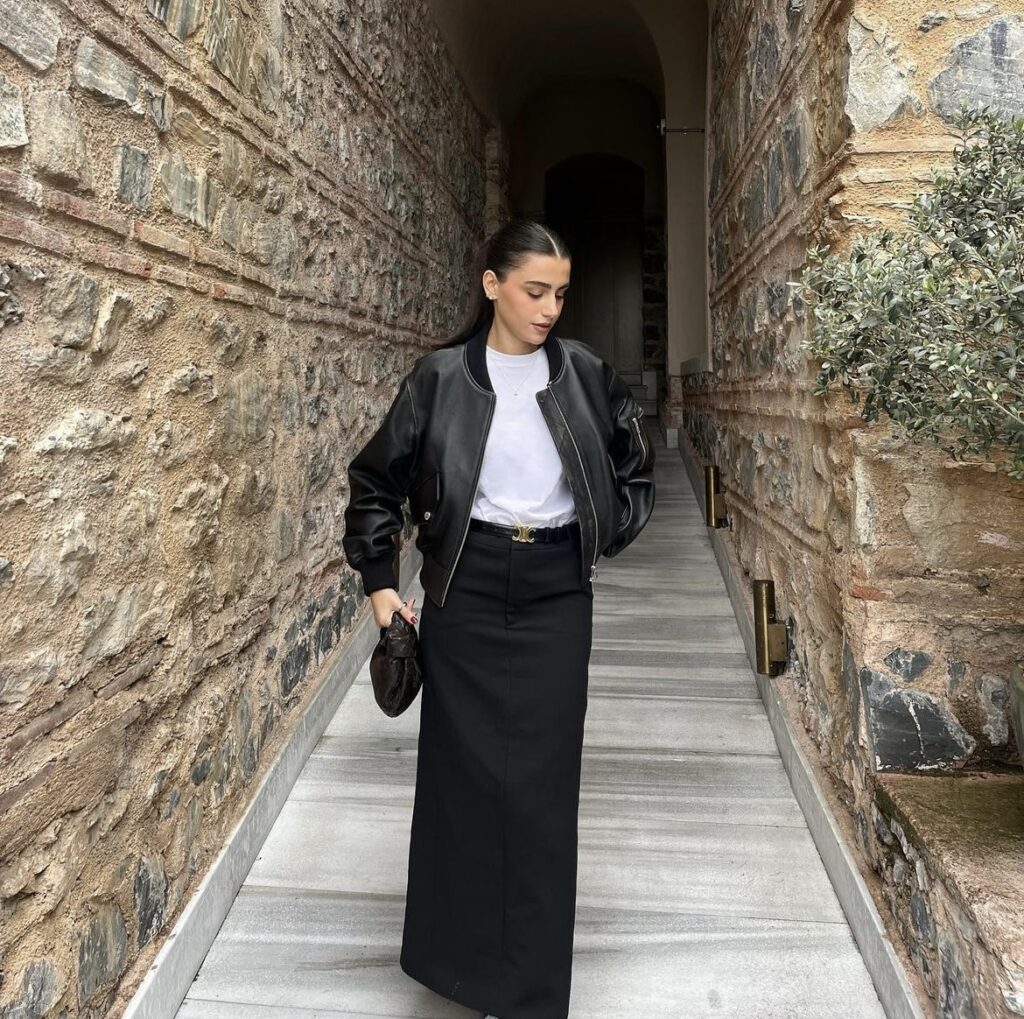 Black leather jacket with a white t-shirt and black maxi skirt.