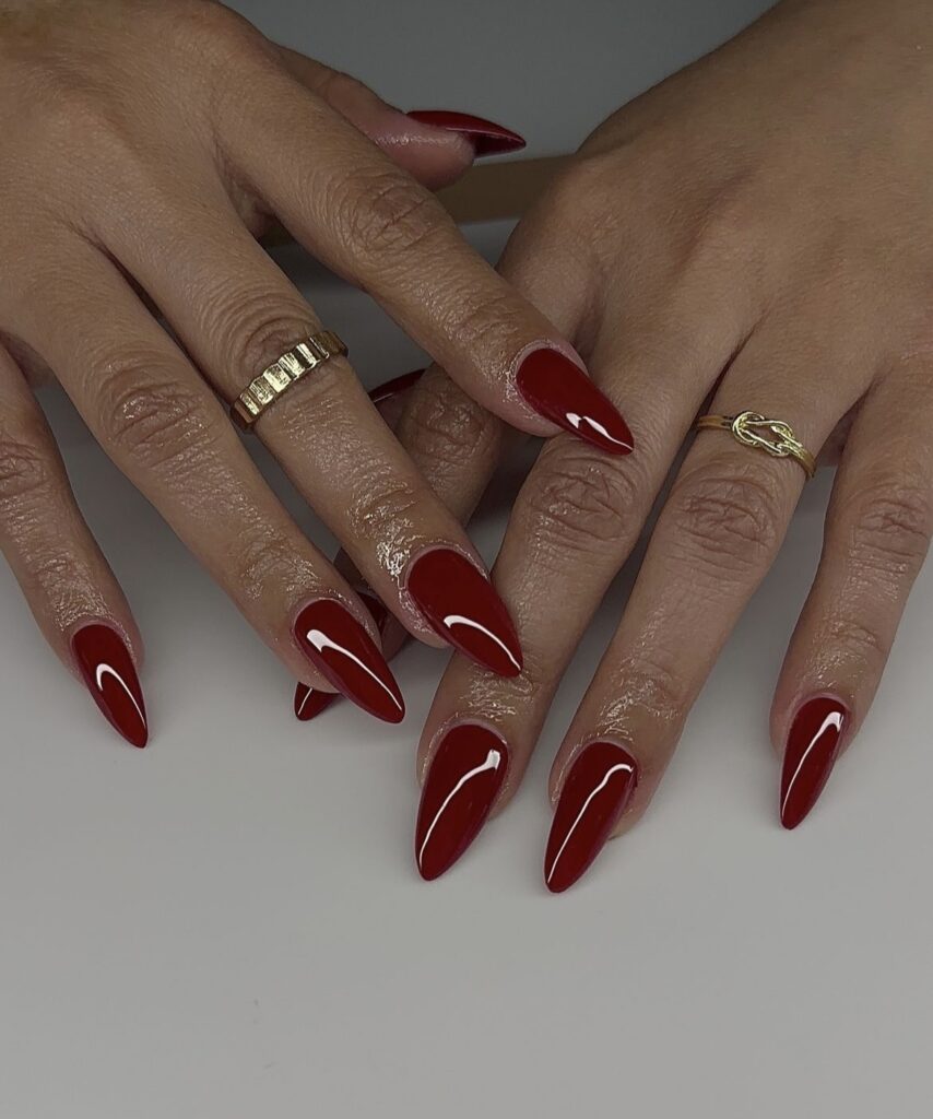 Timeless winter nail design with deep red glossy nails.